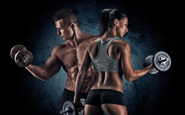 Athletic man and woman with a dumbells.