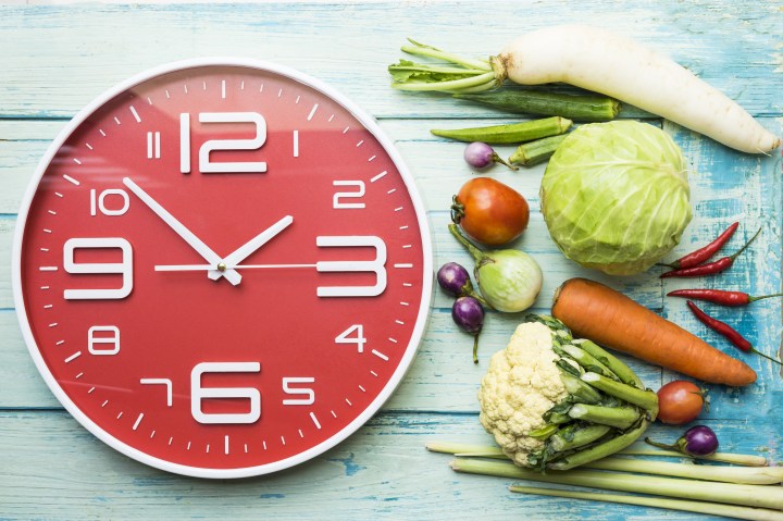 Food clock. Healthy food concept on wooden table